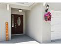 Inviting entryway showcasing a decorative front door with a 'WELCOME' sign and charming floral decorations at 6212 N Grady Ave, Tampa, FL 33614