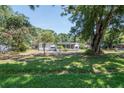 Charming home featuring a screened-in porch and a spacious yard with mature trees at 6226 Florence St, Gibsonton, FL 33534