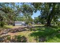 Charming home featuring a screened-in porch and a spacious yard with mature trees at 6226 Florence St, Gibsonton, FL 33534