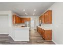 Kitchen featuring wood cabinets, stainless steel appliances, and a breakfast bar at 7412 Bridgeview Dr, Wesley Chapel, FL 33545