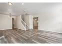 Spacious living room featuring wood floors and a staircase leading to the upper level at 7412 Bridgeview Dr, Wesley Chapel, FL 33545