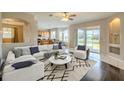 Bright living room with stylish furniture, hardwood floors, and sliding glass doors leading to the outdoors at 7852 Stoney Hill Dr, Wesley Chapel, FL 33545