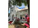 Charming two-story home boasting a stucco facade, arched entryway, and red-tiled roof at 1020 38Th N Ave, St Petersburg, FL 33704