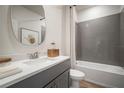 Modern bathroom features a tiled shower-tub combination, stylish vanity, and neutral color palette at 10709 Wading River Ave, Parrish, FL 34219