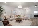 Bright living room featuring modern decor, comfortable seating, and stylish lighting fixtures at 10709 Wading River Ave, Parrish, FL 34219