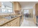Well-lit kitchen with tile flooring, granite countertops and stainless steel appliances at 1118 Lodestar Dr, Holiday, FL 34690