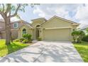 Charming single-story home with well-manicured lawn, mature trees, and a two-car garage at 12204 Coldstream Ln, Tampa, FL 33626