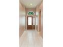 Inviting foyer with a decorative front door, tile flooring, and neutral wall paint at 12204 Coldstream Ln, Tampa, FL 33626