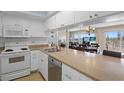 The kitchen features white appliances and ample counter space at 13440 Gulf Blvd # 202, Madeira Beach, FL 33708