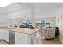 Open-concept living space with kitchen, dining, and living areas at 13440 Gulf Blvd # 202, Madeira Beach, FL 33708