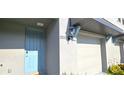 A welcoming entrance featuring a blue door, detailed trim, and a carriage light at 17015 Coral Key Dr, Nokomis, FL 34275
