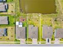 Aerial view showcases property lines with a pond and nearby playground for outdoor enjoyment at 17618 Cortes Creek Blvd, Spring Hill, FL 34610