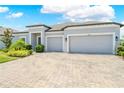 Single-story home with a three-car garage and well-manicured lawn, great curb appeal at 17618 Cortes Creek Blvd, Spring Hill, FL 34610
