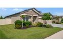 Well-maintained home featuring a manicured lawn and landscaping, showcasing its curb appeal at 18428 Malinche Loop, Spring Hill, FL 34610
