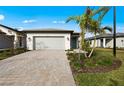 Beautiful single-story home with a paver driveway, two-car garage, and well-maintained landscaping at 1978 Pepper Grass Dr, North Port, FL 34289