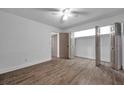 Spacious bedroom with ceiling fan, wood-look tile flooring, closet, and neutral paint at 2353 Shelley St # 6, Clearwater, FL 33765