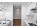 Bright kitchen leads to the bedroom, showcasing white appliances and contemporary finishes at 2353 Shelley St # 6, Clearwater, FL 33765