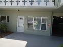 Front door with sidelight windows, exterior unit number, and adjacent carport at 2447 Ecuadorian Way # 11, Clearwater, FL 33763