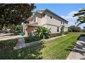 Townhouse with lush green lawn and well-maintained landscaping at 2542 Glenrise Pl, Wesley Chapel, FL 33544