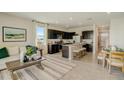 Open concept kitchen with dark cabinets, stainless steel appliances, and a large island with counter seating at 255 Royal Spoonbill Dr, Ruskin, FL 33570