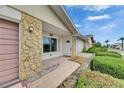 Exterior of charming single-story home with stone accents and well-maintained landscaping at 339 Club Manor Dr, Sun City Center, FL 33573