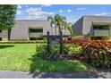 Lahinch Lodges features lush landscaping around building number five with palm trees and colorful flowers at 36750 Us 19 N # 08204, Palm Harbor, FL 34684