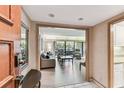 Inviting living room featuring wood floors, comfortable seating, and a large window with a view of the outdoor terrace at 36750 Us 19 N # 08204, Palm Harbor, FL 34684