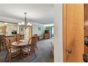 Open concept dining room with a wood table, seating for 6 and living area beyond at 36750 Us 19 N # 15309, Palm Harbor, FL 34684