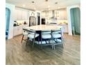 Spacious kitchen with white cabinetry, stainless steel appliances, and a large center island with seating at 3952 Aldea Way, Wesley Chapel, FL 33543