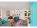 Open living room featuring stylish decor, a colorful rug, and easy access to the kitchen at 4324 S Clark Ave, Tampa, FL 33611