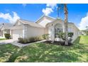 This well-maintained one-story home boasts lush landscaping and a serene curb appeal at 4921 Wessex Way, Land O Lakes, FL 34638