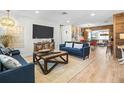 Cozy living room with a large TV, rustic wood accents, and comfortable blue sofas at 501 Janice Pl, Indian Rocks Beach, FL 33785