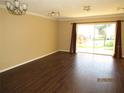 Bright living room with wood floors, ample natural light and sliding glass doors to private patio at 5110 Sunridge Palms Dr, Tampa, FL 33617