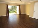 Bright living room with wood floors, ample natural light and sliding glass doors to private patio at 5110 Sunridge Palms Dr, Tampa, FL 33617