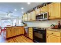 Bright kitchen with wooden cabinets, stainless steel appliances, and granite countertops, perfect for cooking at 550 Salmon Ct, Oldsmar, FL 34677