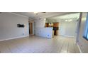 Bright living room featuring tile flooring, an open layout, and neutral paint at 6825 Hammock Rd, Port Richey, FL 34668