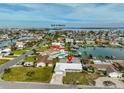 Aerial view of a waterfront home near the Gulf of Mexico, surrounded by other houses and canals at 710 116Th Ave, Treasure Island, FL 33706