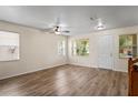 Sunlit living room showcases hardwood floors, ceiling fan, and a welcoming front entrance at 7249 Bridgeview Dr, Wesley Chapel, FL 33545
