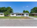 Charming one story home featuring a covered entry and an attached one car garage at 7500 16Th N St, St Petersburg, FL 33702