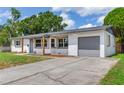 Charming one story home featuring a covered entry, an attached one car garage and a large driveway at 7500 16Th N St, St Petersburg, FL 33702