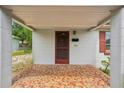 Welcoming covered front porch with decorative tile flooring leading to the home's entrance at 7511 N Ola Ave, Tampa, FL 33604