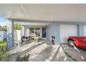 Spacious carport with a garage and seating area, providing ample parking and storage at 108 Shore Dr, Tarpon Springs, FL 34689