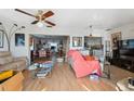 Inviting living room with hardwood floors, ceiling fan, and open layout, great for entertaining at 108 Shore Dr, Tarpon Springs, FL 34689
