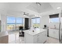 Bright, modern kitchen featuring stainless appliances and a large island with views of the beach at 11500 Gulf Blvd # 513, Treasure Island, FL 33706