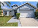 Charming single Gathering home with a two-car garage, arched windows and well-maintained landscaping at 12510 Sparkleberry Rd, Tampa, FL 33626