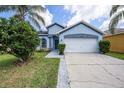 Charming single Gathering home with a two-car garage and well-maintained landscaping at 12510 Sparkleberry Rd, Tampa, FL 33626