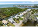 Stunning aerial view of waterfront homes with docks and canal access to the open bay waters at 14409 Birch St, Hudson, FL 34667