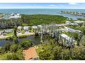 Aerial view of waterfront homes with canal access, close to a beautiful open bay view at 14409 Birch St, Hudson, FL 34667