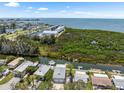 Aerial view of waterfront homes with canal access and beautiful open bay view in the distance at 14409 Birch St, Hudson, FL 34667