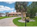 Traditional home boasts mature landscaping, a circular driveway and a mailbox with address at 14564 110Th Ter, Largo, FL 33774